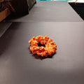 Orange crocheted Halloween hair tie made with glow-in-the-dark cotton