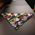 Medium Halloween pet bandana in a skull and bats print with orange, purple, and green stripes