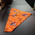 Extra large Halloween pet bandana in an orange print with wizard characters, pumpkins, stars, and spider webs
