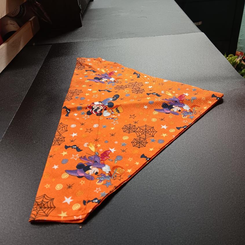 Extra large Halloween pet bandana in an orange print with wizard characters, pumpkins, stars, and spider webs